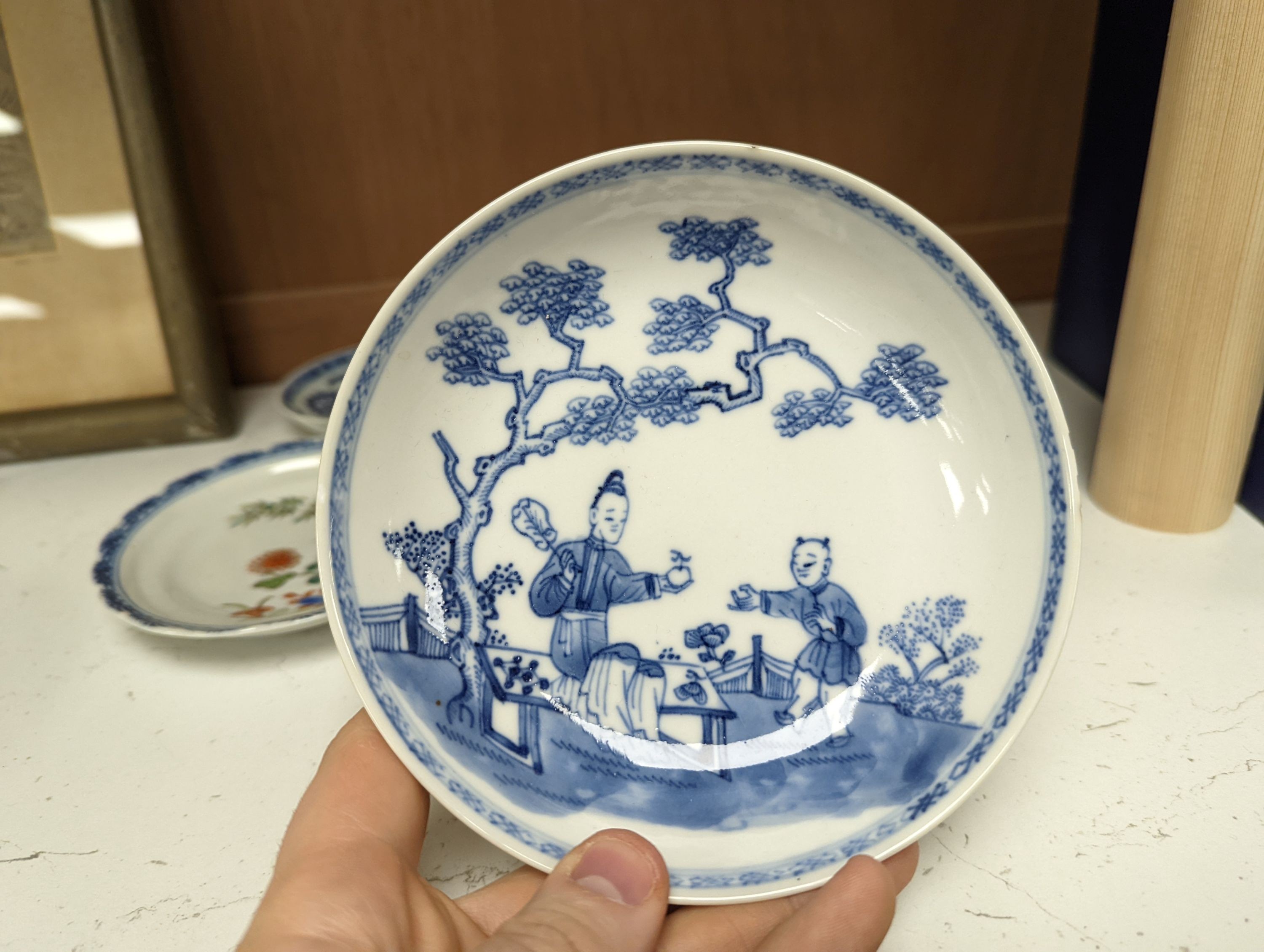 Seven 18th century Chinese saucer dishes, largest 14 cms diameter.